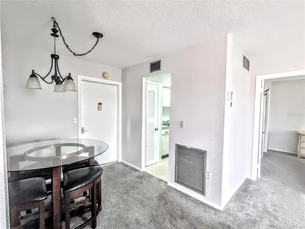 a view of a room that has a table and chairs in it