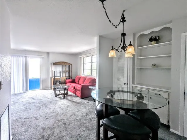 a dining room with furniture and window