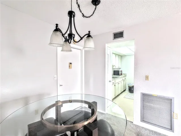 a dining room with a table and chairs