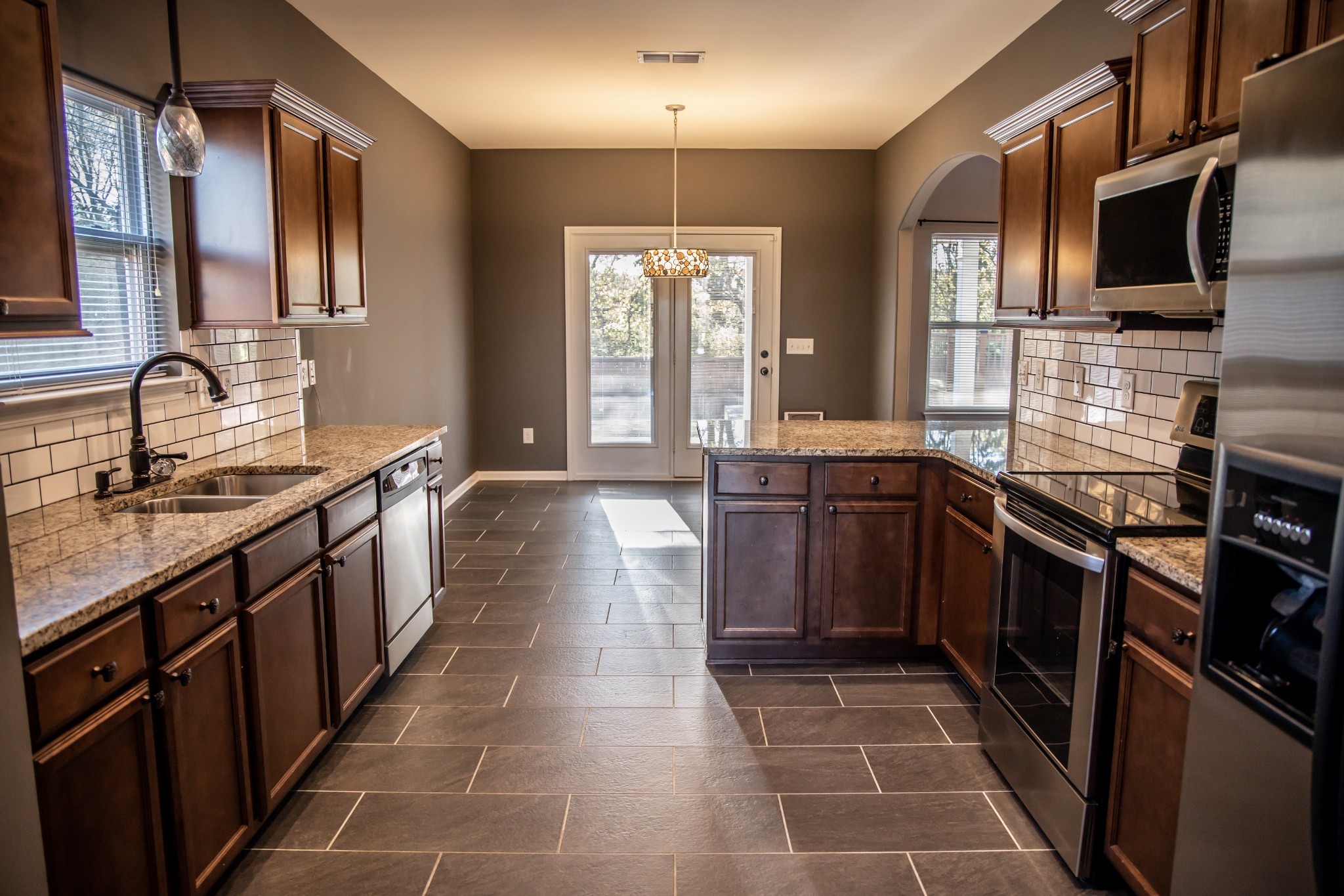 2030 Lincoln Road Spring Hill, TN 37174 - Photo 7 of 29 a large kitchen with stainless steel appliances granite countertop a sink stove and refrigerator