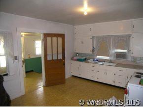 504 Barnard Road Marshall, NC 28753 - Photo 4 of 12 a spacious bathroom with a granite countertop sink and a mirror