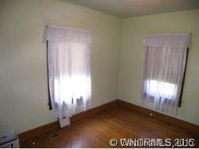 504 Barnard Road Marshall, NC 28753 - Photo 6 of 12 a view of empty room with wooden floor and fan