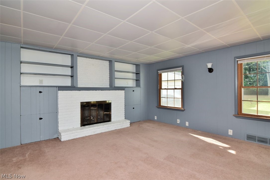 5284 Edenhurst Road Lyndhurst, OH 44124 - Photo 25 of 50 Built-in shelving, white brick fireplace, paneling, and two pane windows