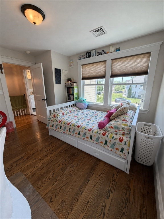 17 Cardinal Street, Unit 17 Winchester, MA 01890 - Photo 24 of 42 a bedroom with a bed mirror and window