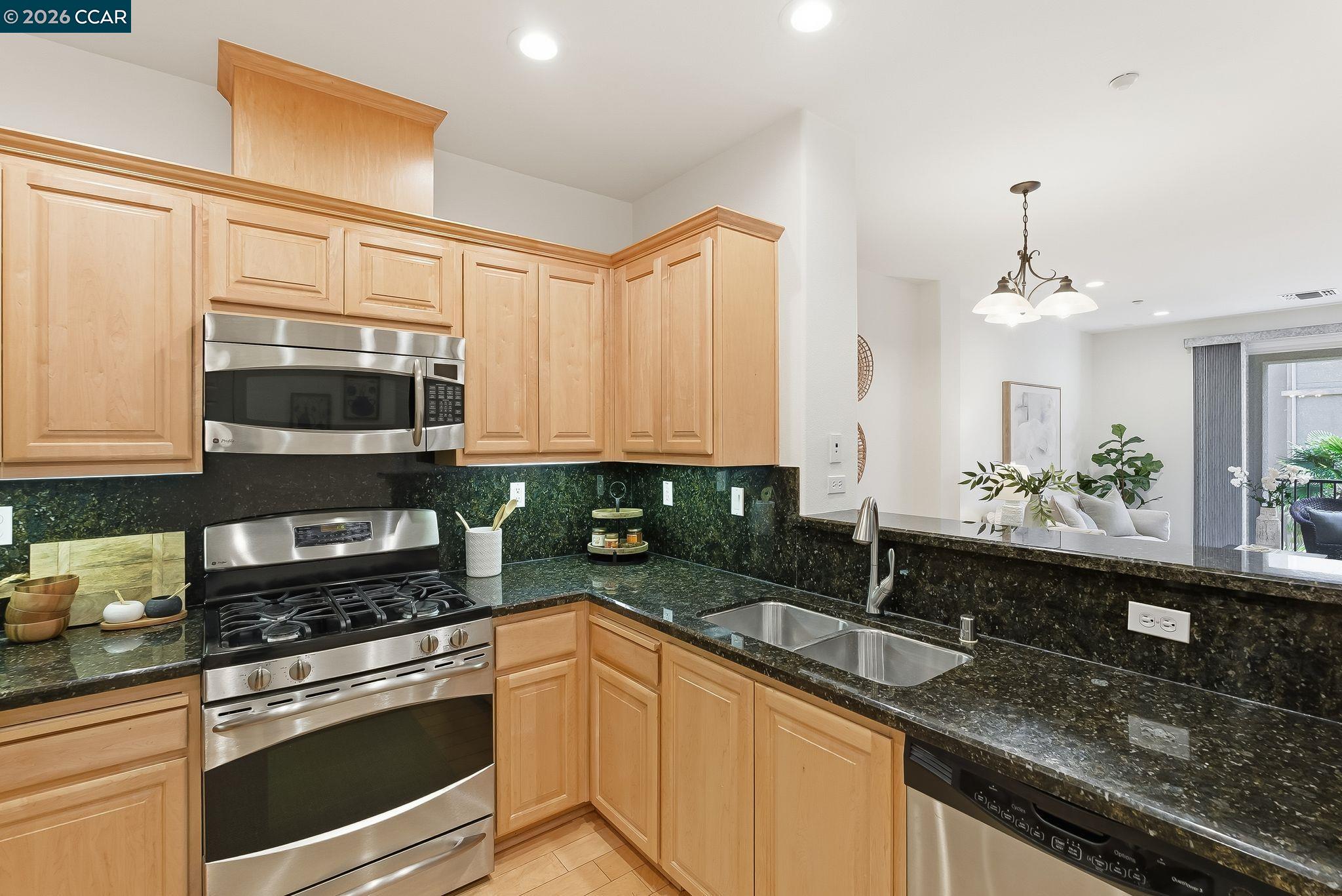 Dublin Ranch Dublin, CA 94568 - Photo 5 of 18 a kitchen with stainless steel appliances granite countertop a sink a stove and a microwave