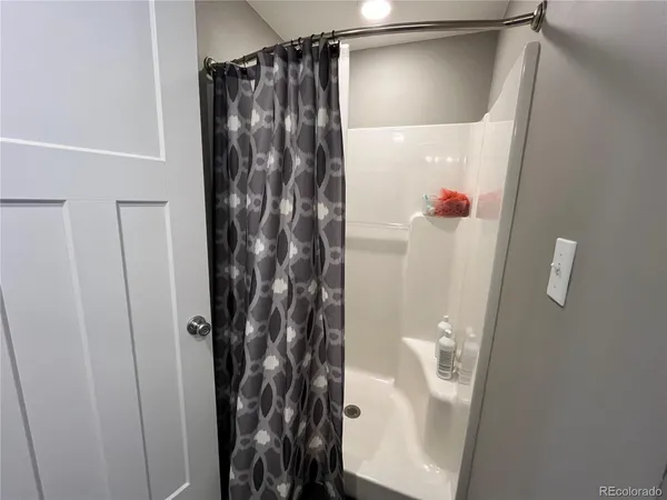 a bathroom with a shower and a tub