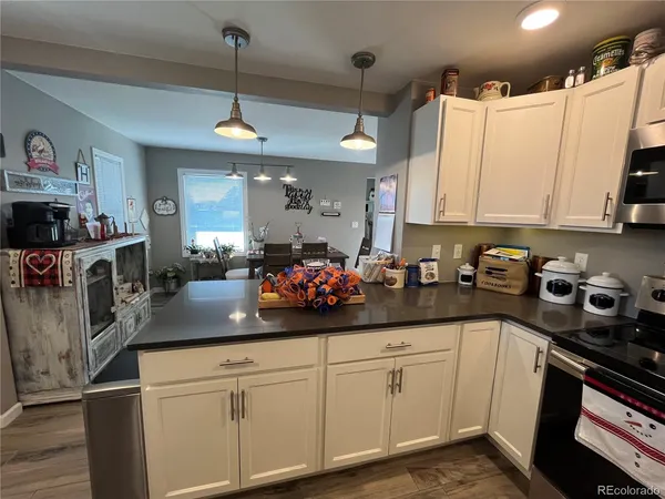 a kitchen with white cabinets and sink