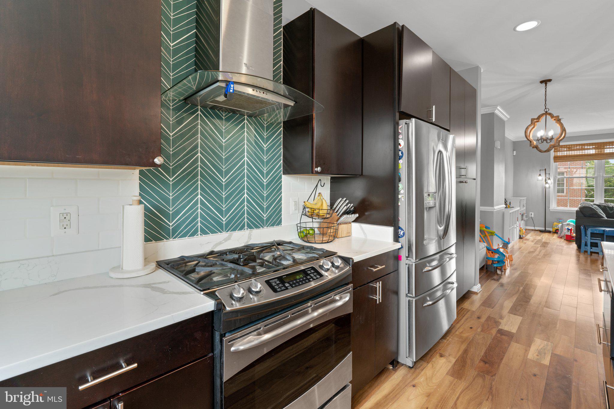 1338 Lowman Street Baltimore, MD 21230 - Photo 12 of 72 a kitchen with stainless steel appliances granite countertop a stove a refrigerator and a microwave