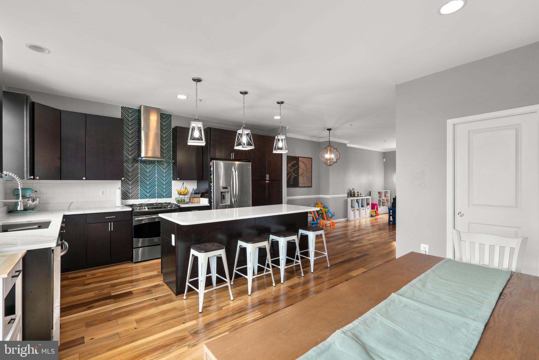 1338 Lowman Street Baltimore, MD 21230 - Photo 16 of 72 a large kitchen with a table and chairs