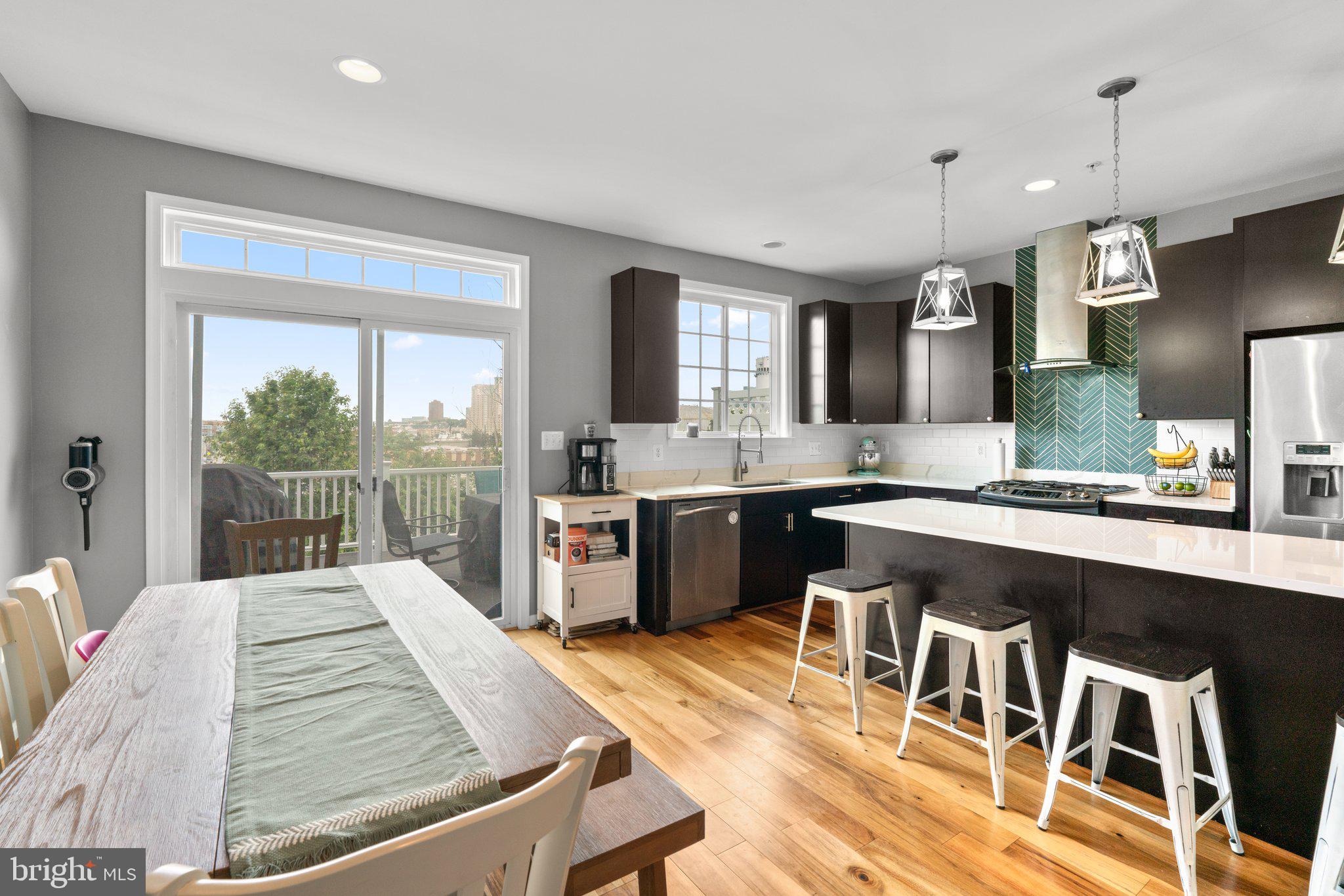 1338 Lowman Street Baltimore, MD 21230 - Photo 17 of 72 a kitchen with a table chairs sink and cabinets
