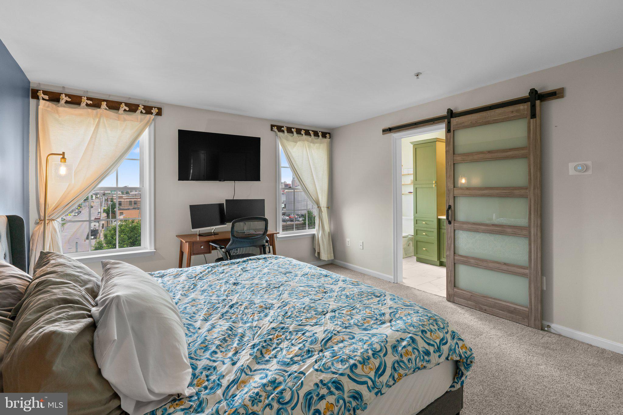 1338 Lowman Street Baltimore, MD 21230 - Photo 32 of 72 a spacious bedroom with a bed and glass door