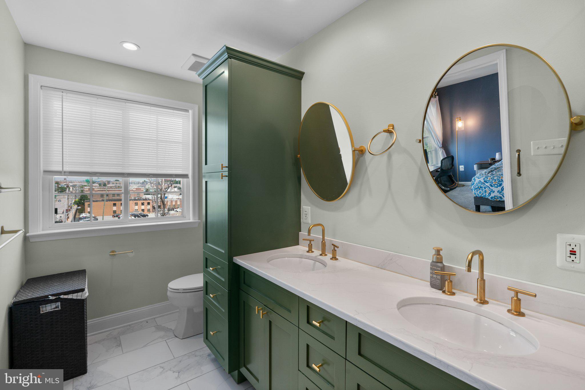 1338 Lowman Street Baltimore, MD 21230 - Photo 36 of 72 a bathroom with a double vanity sink and a mirror