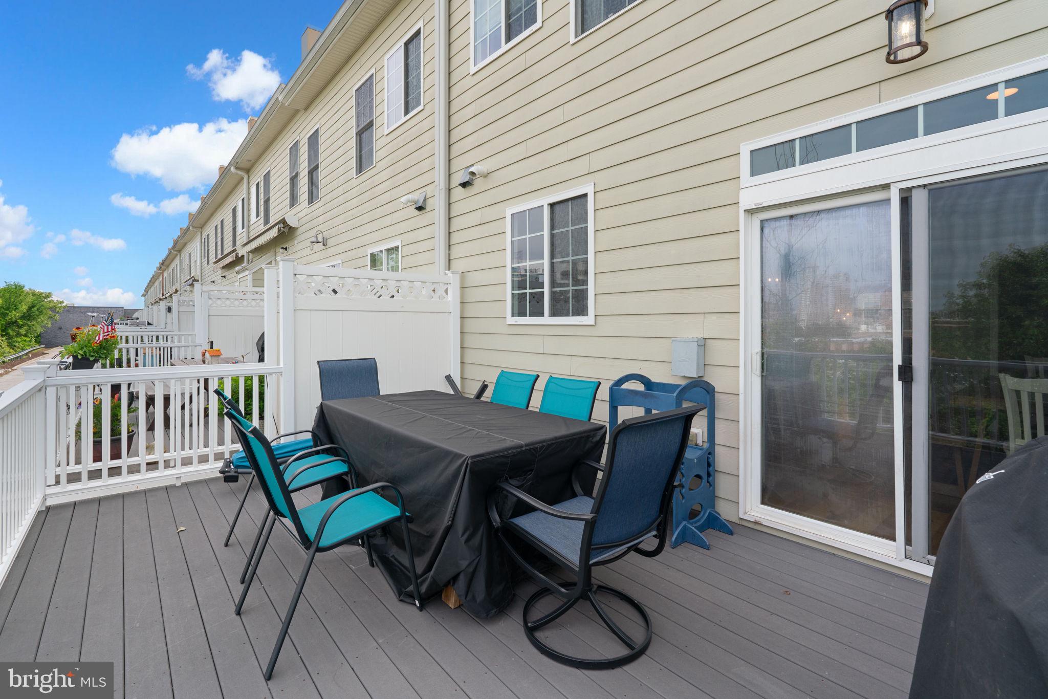1338 Lowman Street Baltimore, MD 21230 - Photo 40 of 72 a view of a patio with table and chairs with wooden floor and fence