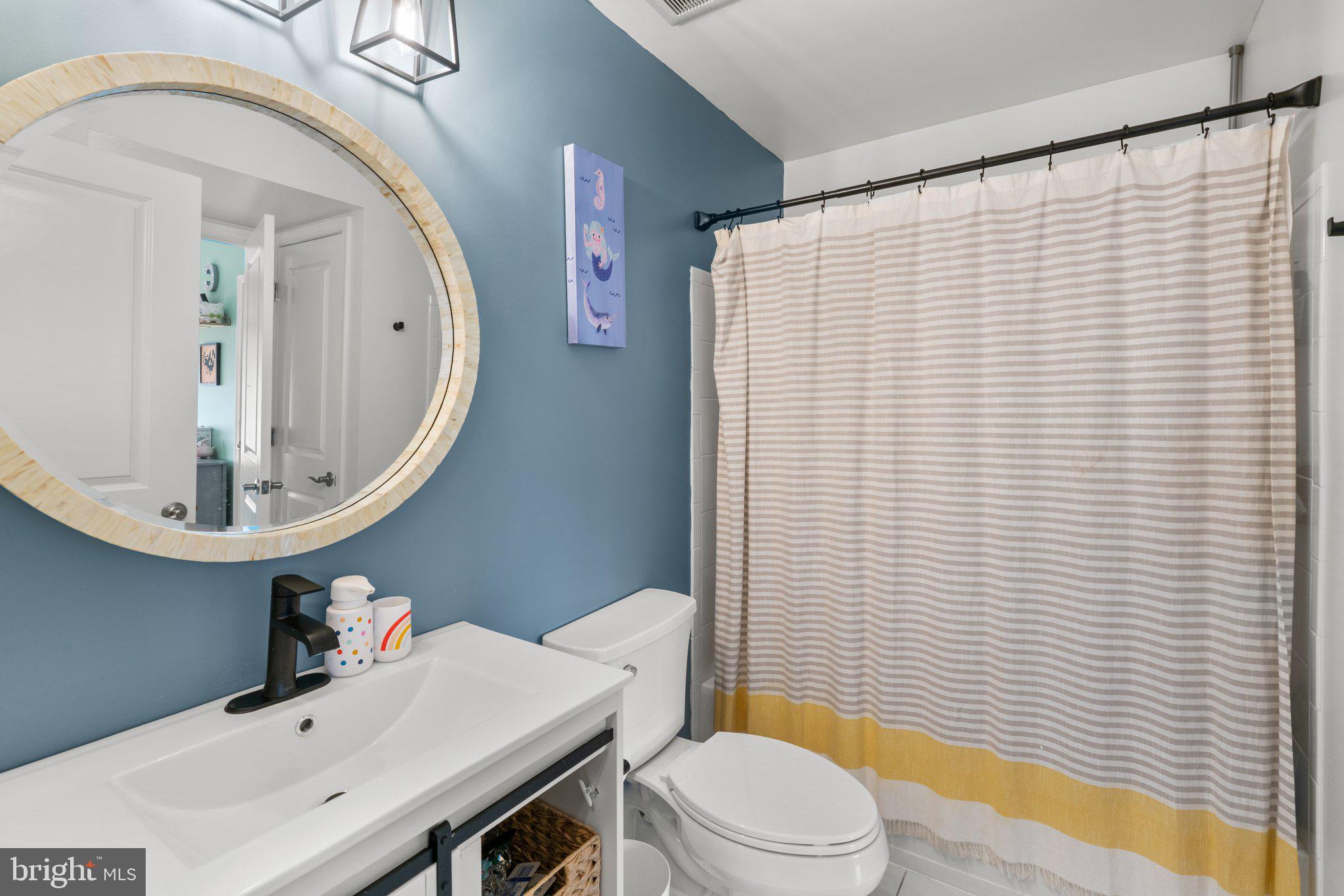 1338 Lowman Street Baltimore, MD 21230 - Photo 42 of 72 a bathroom with a sink a toilet and mirror