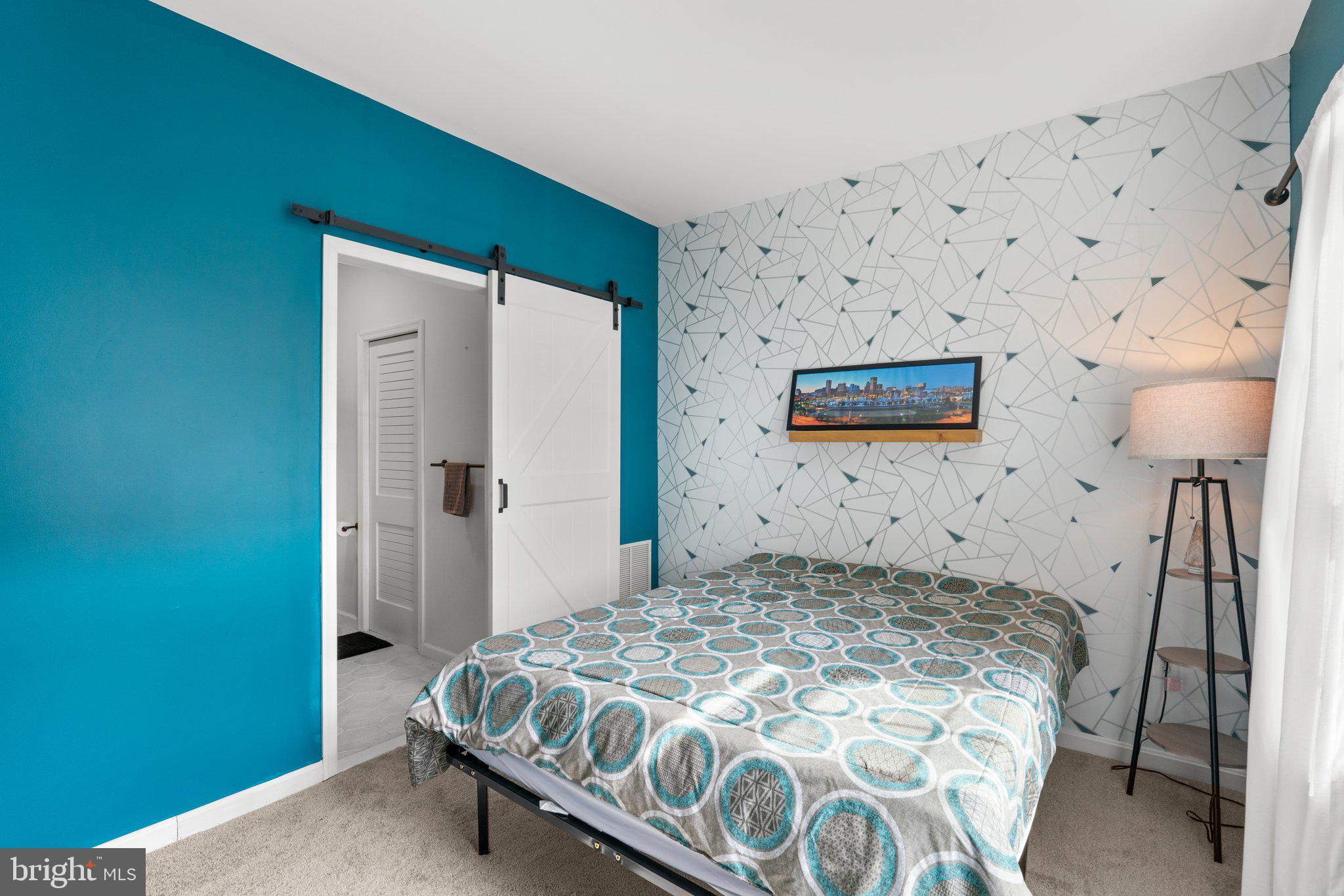 1338 Lowman Street Baltimore, MD 21230 - Photo 5 of 72 a bedroom with a bed and a lamp