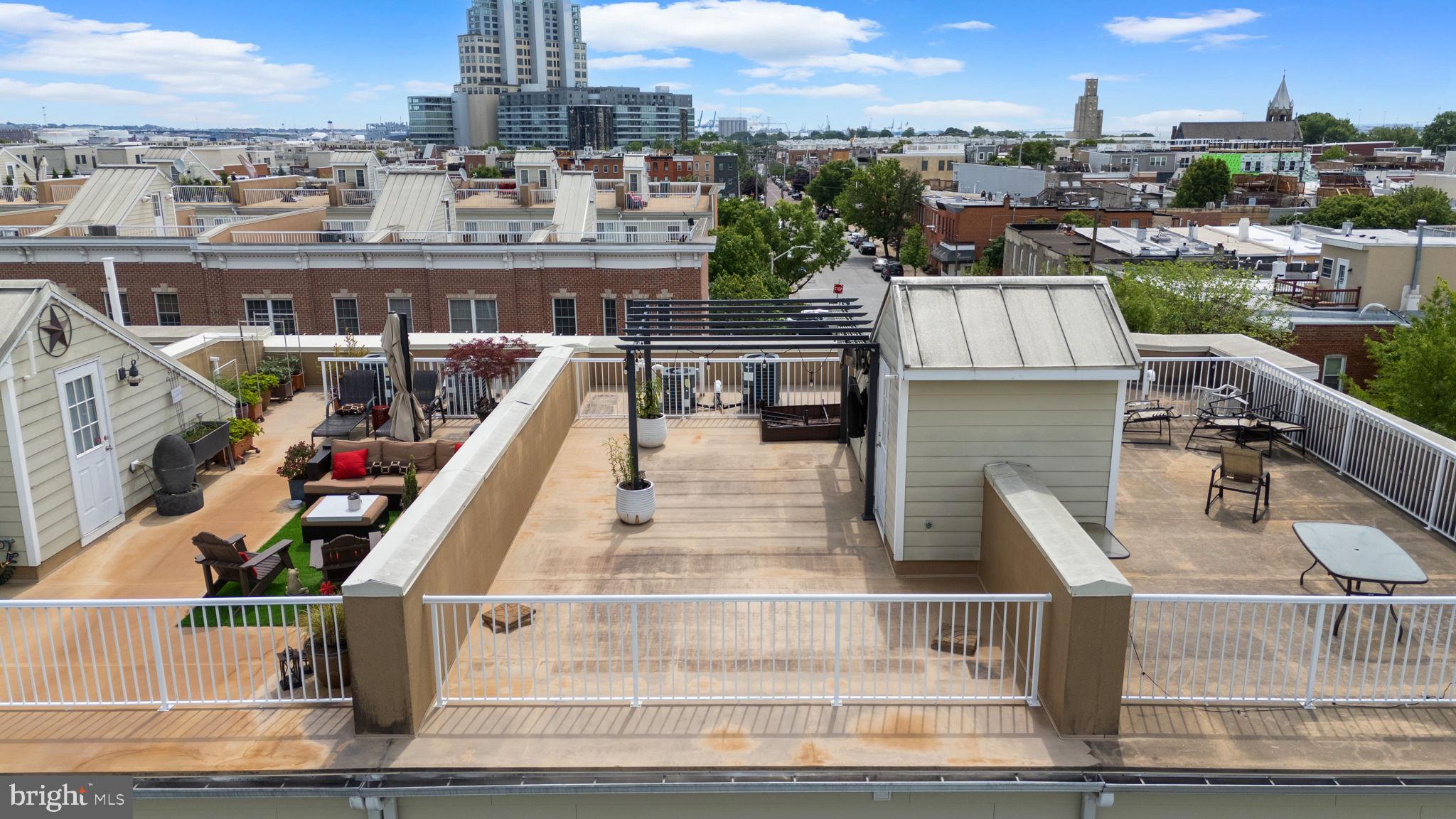 1338 Lowman Street Baltimore, MD 21230 - Photo 53 of 72 a view of a balcony with two chairs and potted plants