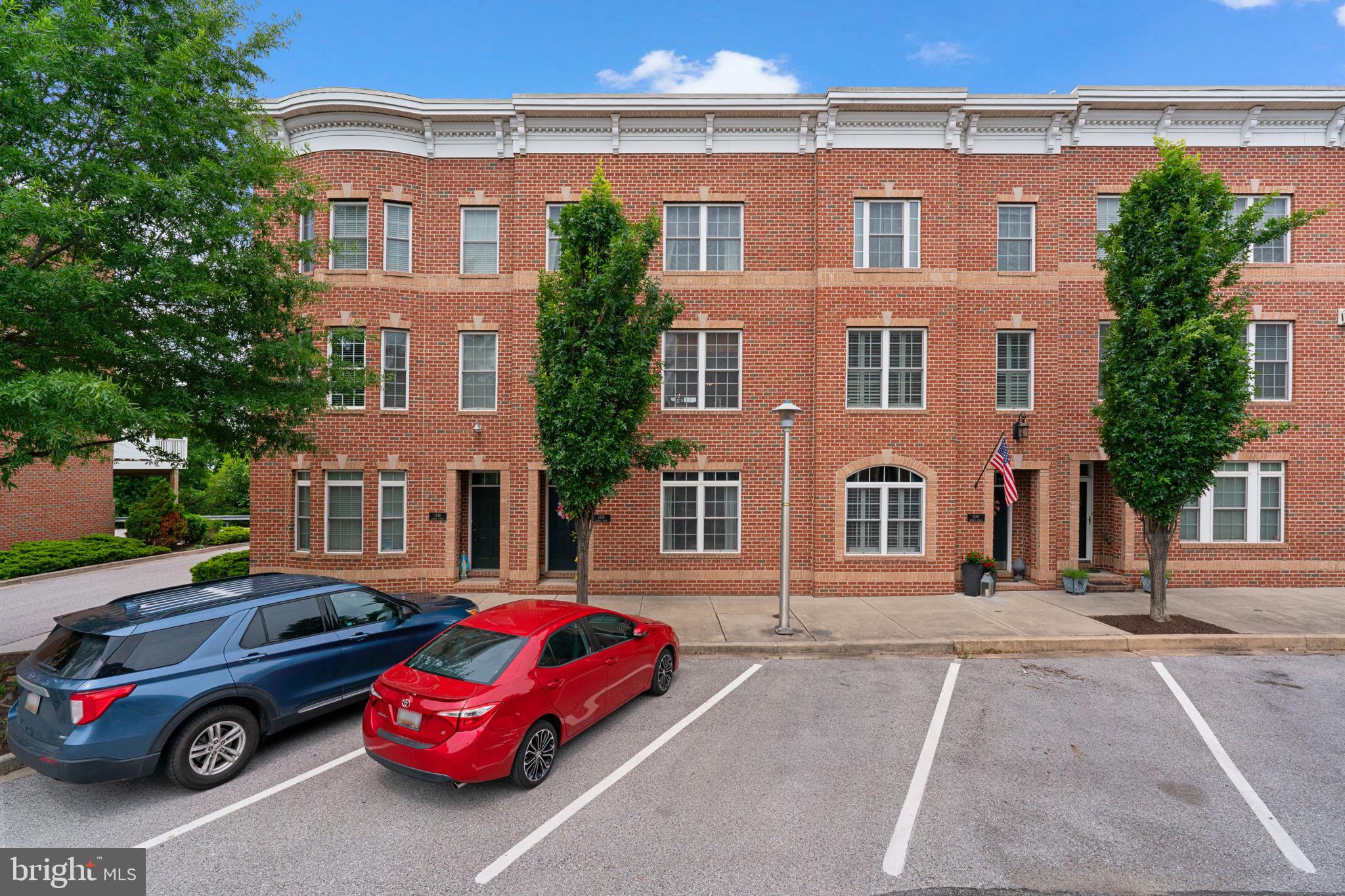 1338 Lowman Street Baltimore, MD 21230 - Photo 56 of 72 a front view of a house with parking space and a car parked in front of it