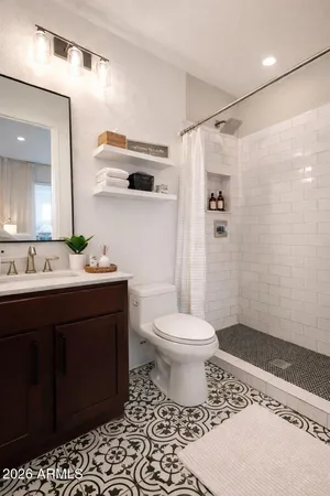 a room with a white furniture cabinets and a window