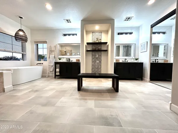 a bedroom with a large bed and a large window