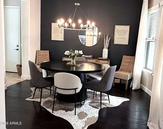 a kitchen with stainless steel appliances kitchen island granite countertop a table chairs and a refrigerator