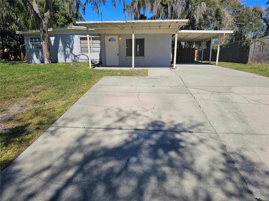 7253 Cedar Point Drive New Port Richey, FL 34653 - Photo 1 of 1 a front view of a house with a yard and a garage