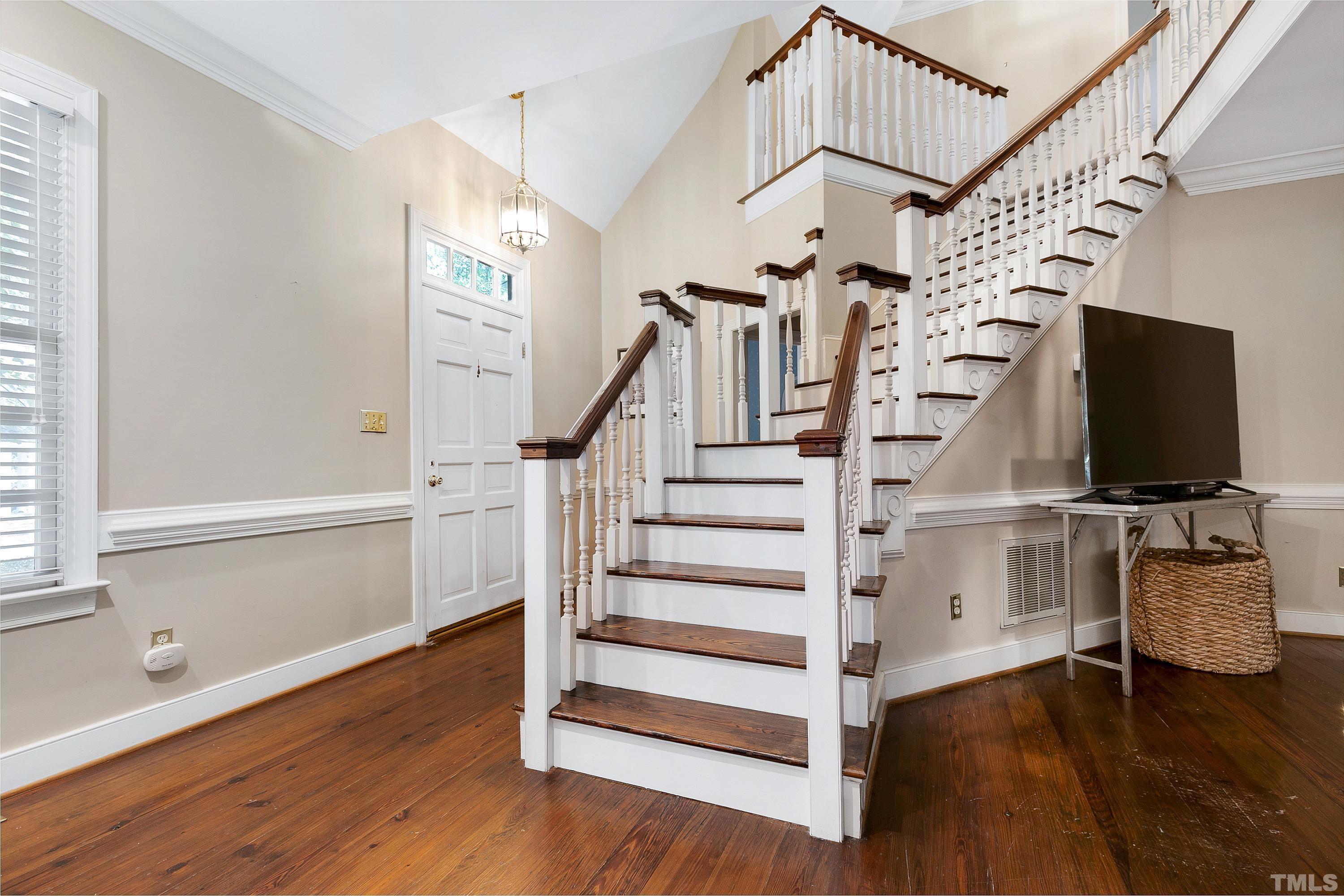 113 Palace Green Cary, NC 27518 - Photo 3 of 32 a view of entryway with wooden floor and stairs