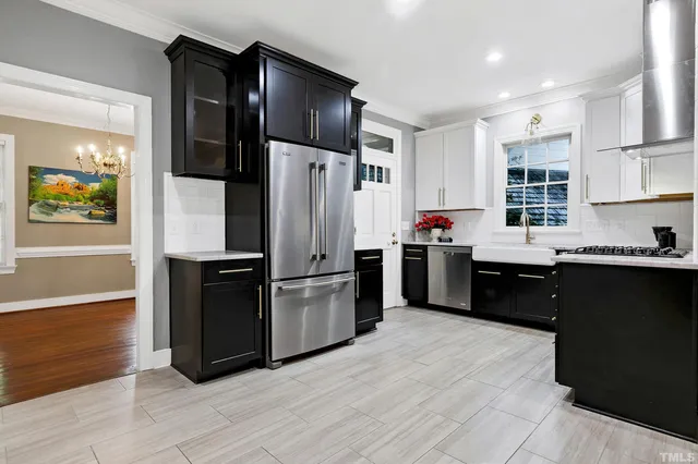 a kitchen with stainless steel appliances granite countertop a stove a sink and a refrigerator