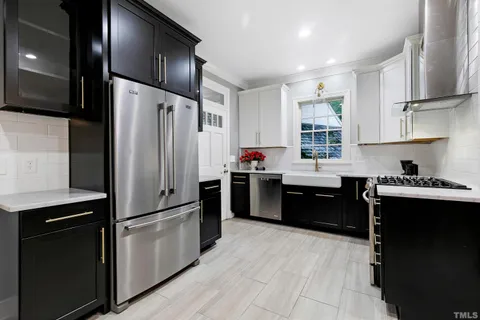 a kitchen with stainless steel appliances kitchen island granite countertop a stove and a sink