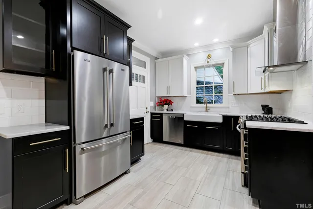 a kitchen with stainless steel appliances kitchen island granite countertop a stove and a sink