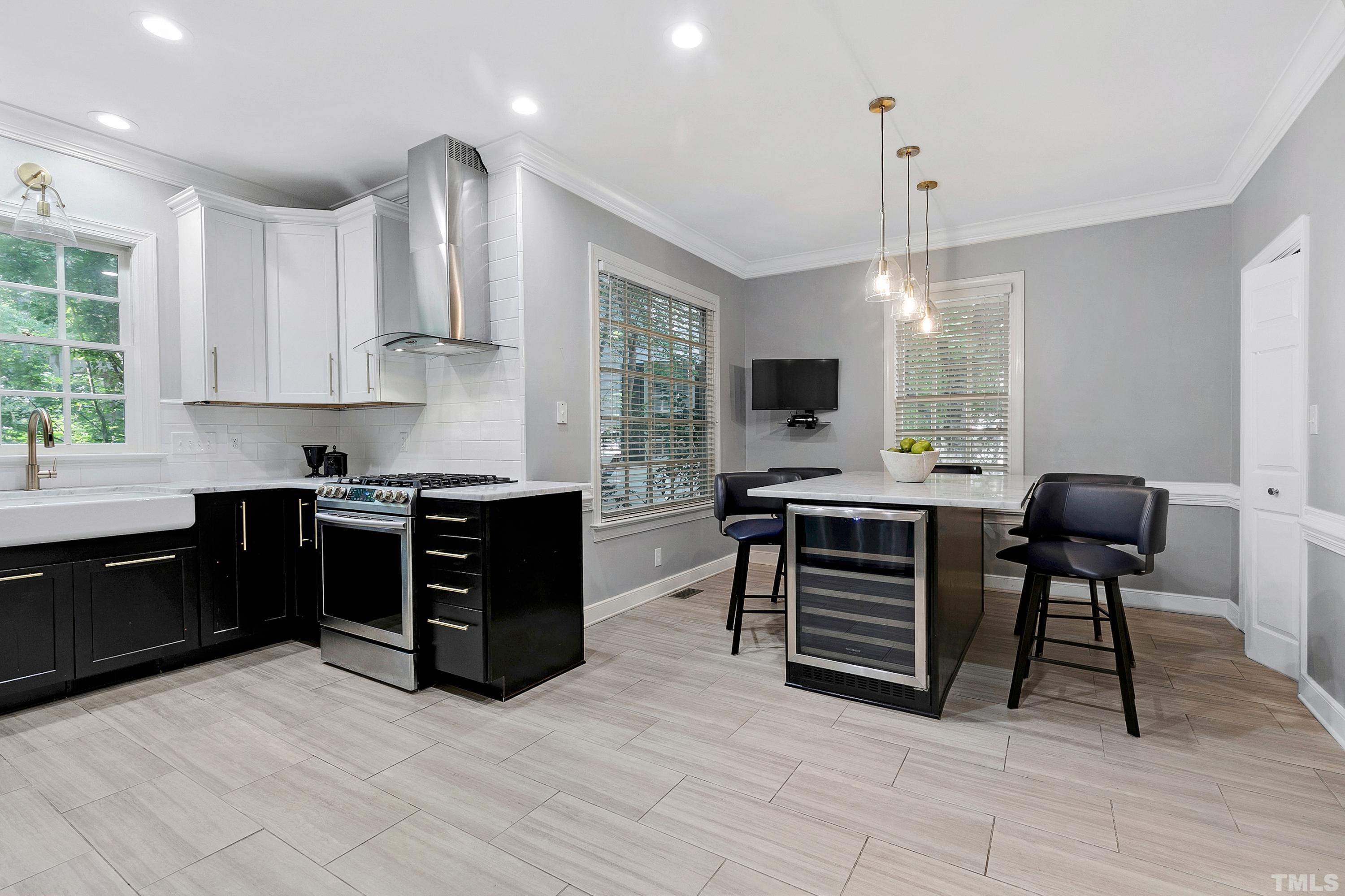113 Palace Green Cary, NC 27518 - Photo 9 of 32 a kitchen with stainless steel appliances kitchen island granite countertop a stove and a sink