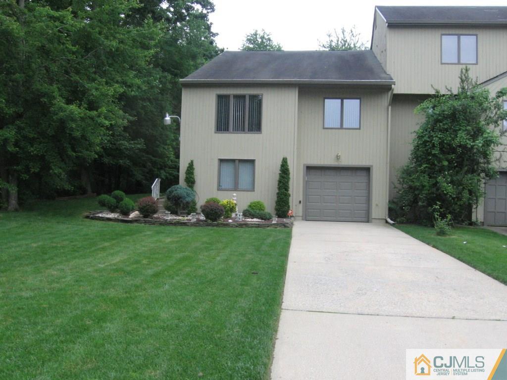 163 Redpine Loop Old Bridge, NJ 08857 - Photo 1 of 20 a front view of a house with a yard and a garage