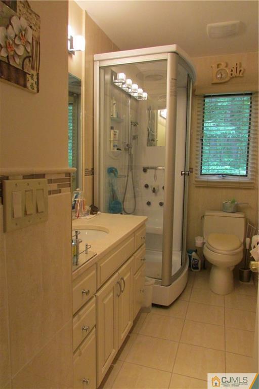 163 Redpine Loop Old Bridge, NJ 08857 - Photo 19 of 20 a bathroom with a granite countertop sink a toilet and shower