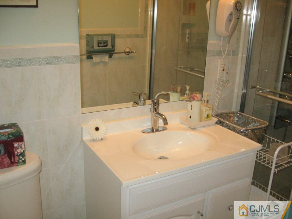 163 Redpine Loop Old Bridge, NJ 08857 - Photo 6 of 20 a bathroom with a sink and a mirror