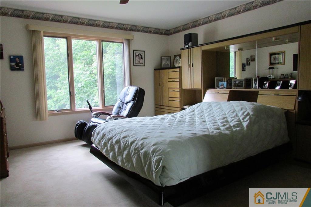 163 Redpine Loop Old Bridge, NJ 08857 - Photo 8 of 20 a bed sitting in a spacious bedroom next to a window