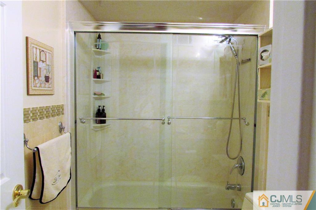 163 Redpine Loop Old Bridge, NJ 08857 - Photo 10 of 20 a bathroom with a glass shower door