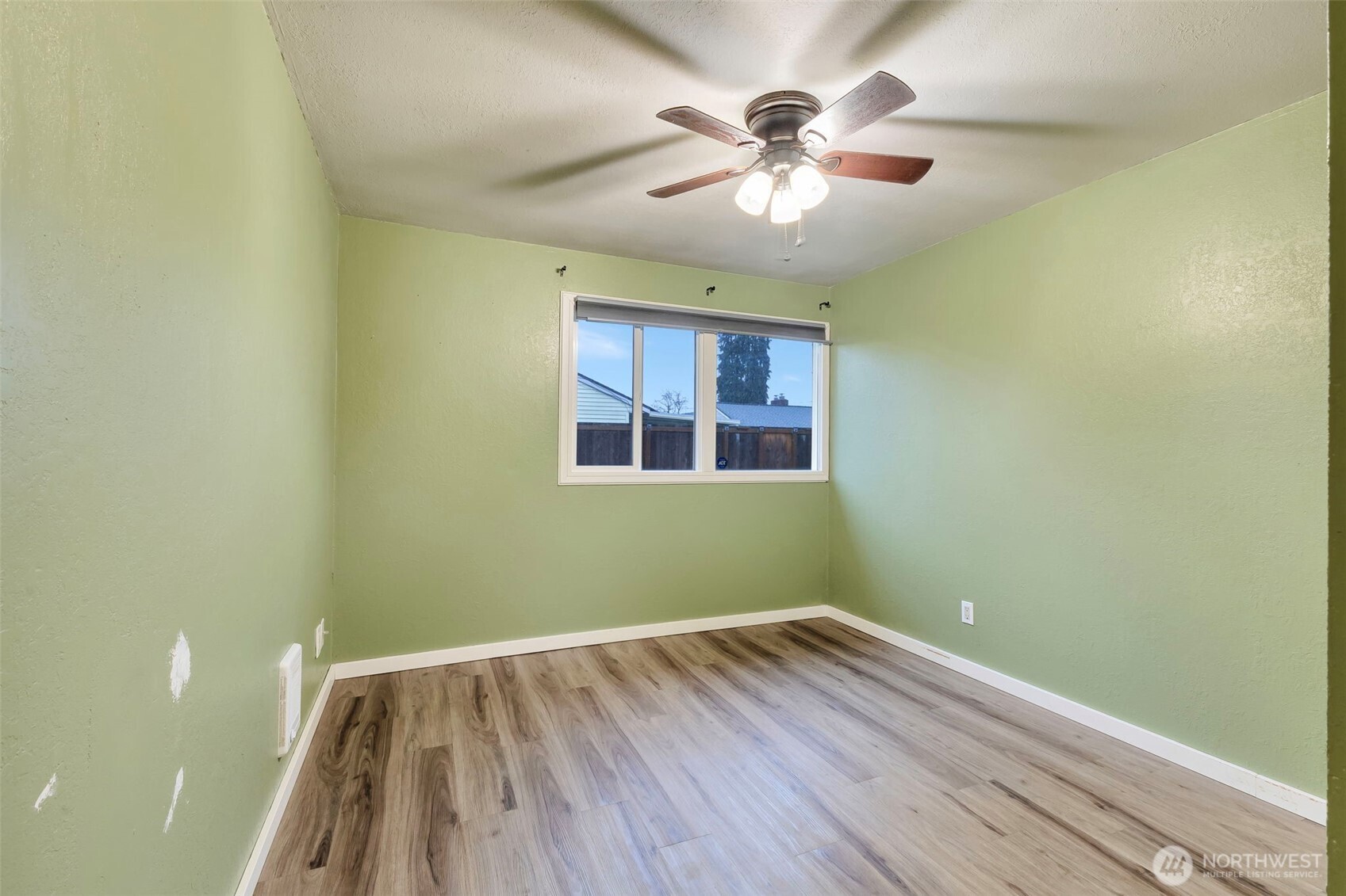 10915 Davisson Road Southwest Lakewood, WA 98499 - Photo 19 of 29 wooden floor in an empty room with a window