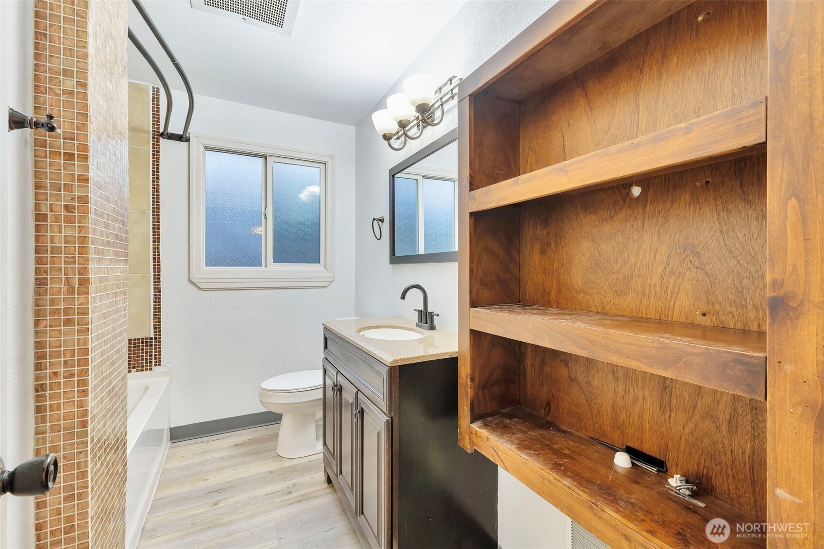10915 Davisson Road Southwest Lakewood, WA 98499 - Photo 22 of 29 a bathroom with a sink a toilet and shower
