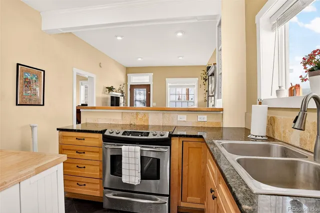 a kitchen that has a sink and a stove