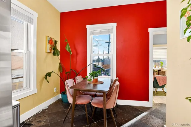 a dining room with furniture and window