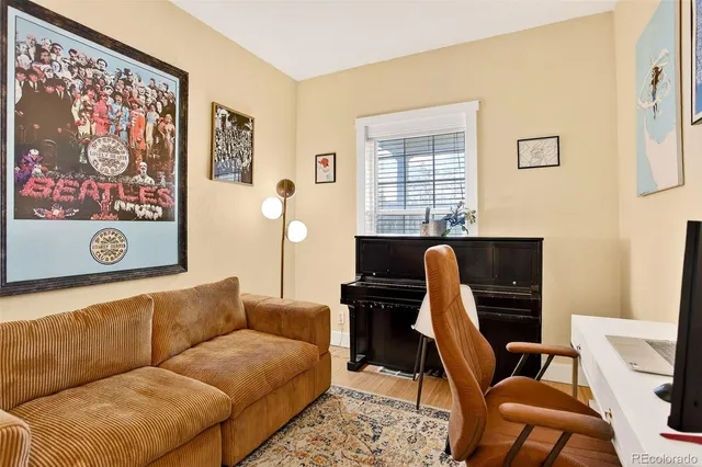 a living room with furniture a flat screen tv and a window