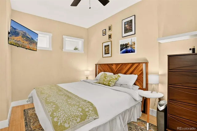 a bedroom with a bed and wall painting