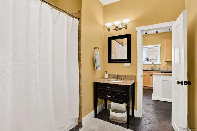 a en suite bathroom with a sink a mirror and a shower