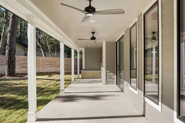 a front view of a house with a yard and trees