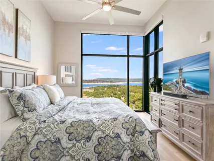 a bedroom with a large bed and a large window