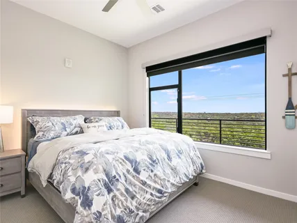 a large bed sitting in a bedroom next to a window