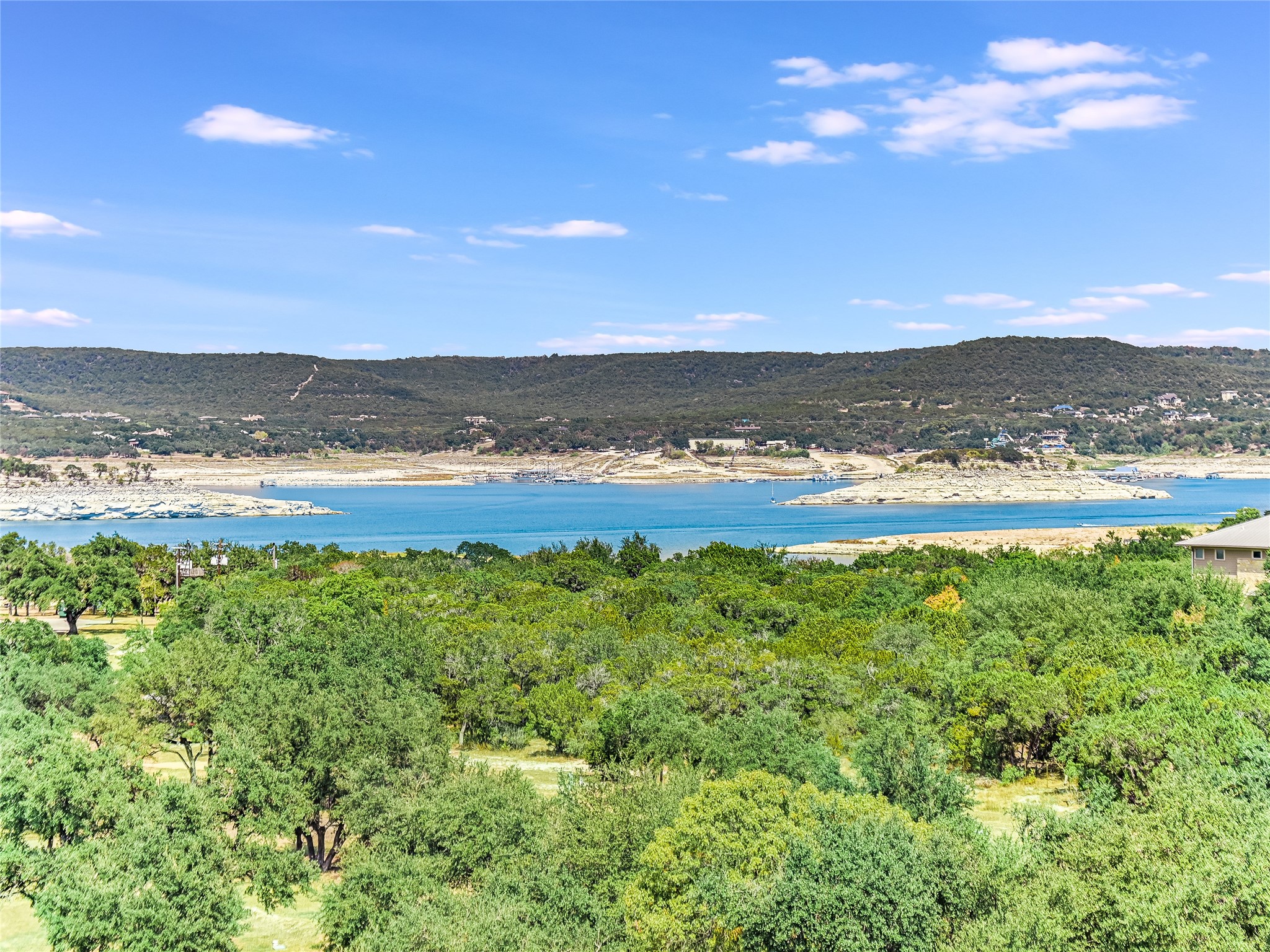 5921 Hiline Road, Unit 1501 Austin, TX 78734 - Photo 2 of 38 Enjoy views of the heavily wooded 14-acre park down below in the foreground as well as incredible stunning views of Lake Travis and beyond from your private covered TOP FLOOR balcony.