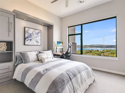 a bedroom with a large bed and a large window