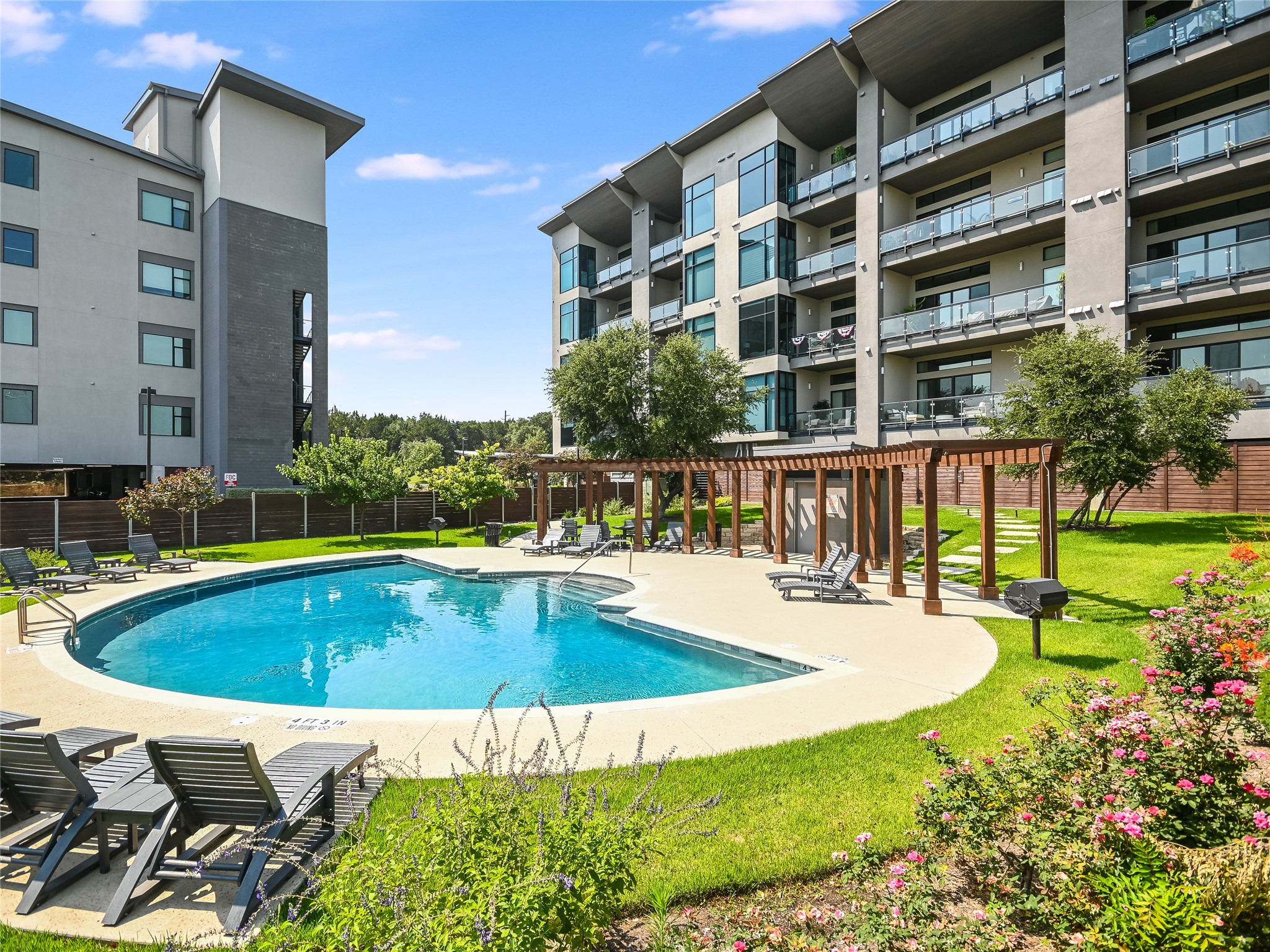 5921 Hiline Road, Unit 1501 Austin, TX 78734 - Photo 29 of 38 Well-manicured common area features fully-fenced community pool, bath, pergola, bbq grills, and lounge chairs.