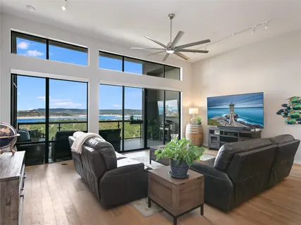 a living room with furniture large windows and a flat screen tv