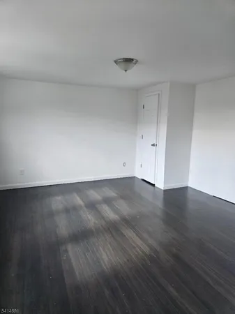 a view of room with wooden floor